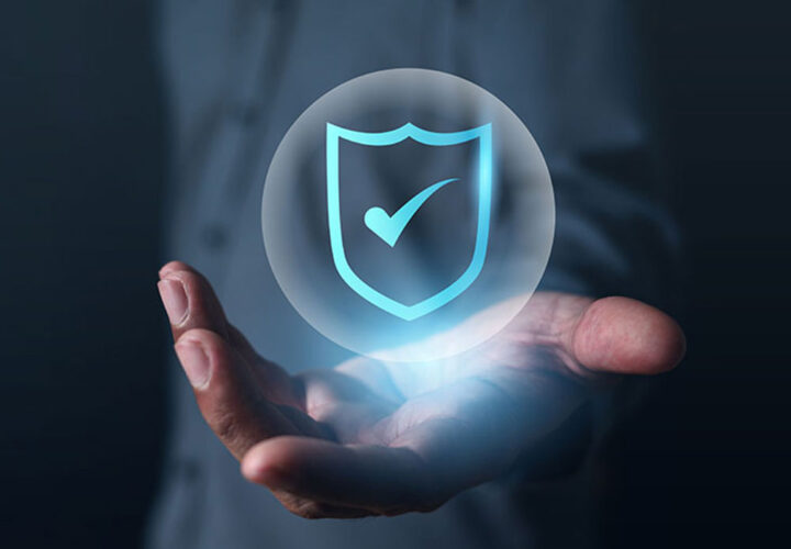 A shield icon on a man's hand